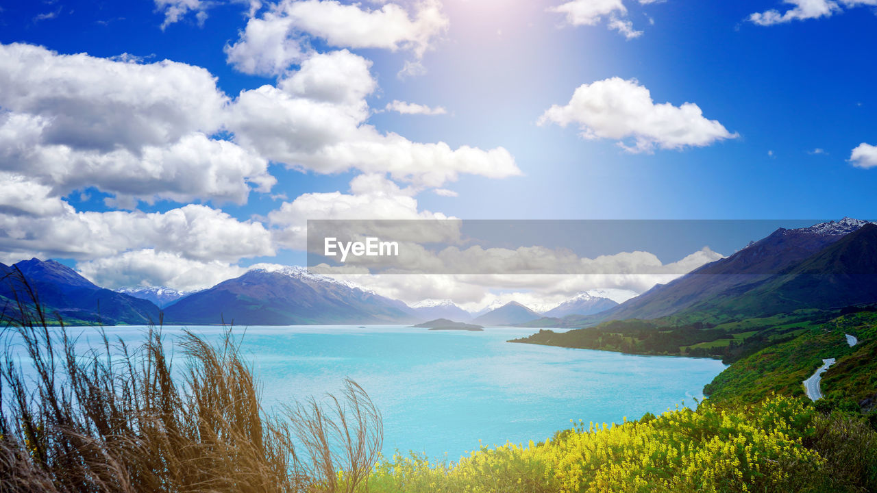Scenic view of lake and mountains against sky