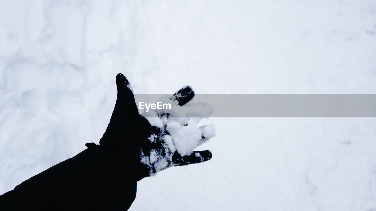 SILHOUETTE HAND ON SNOW FIELD