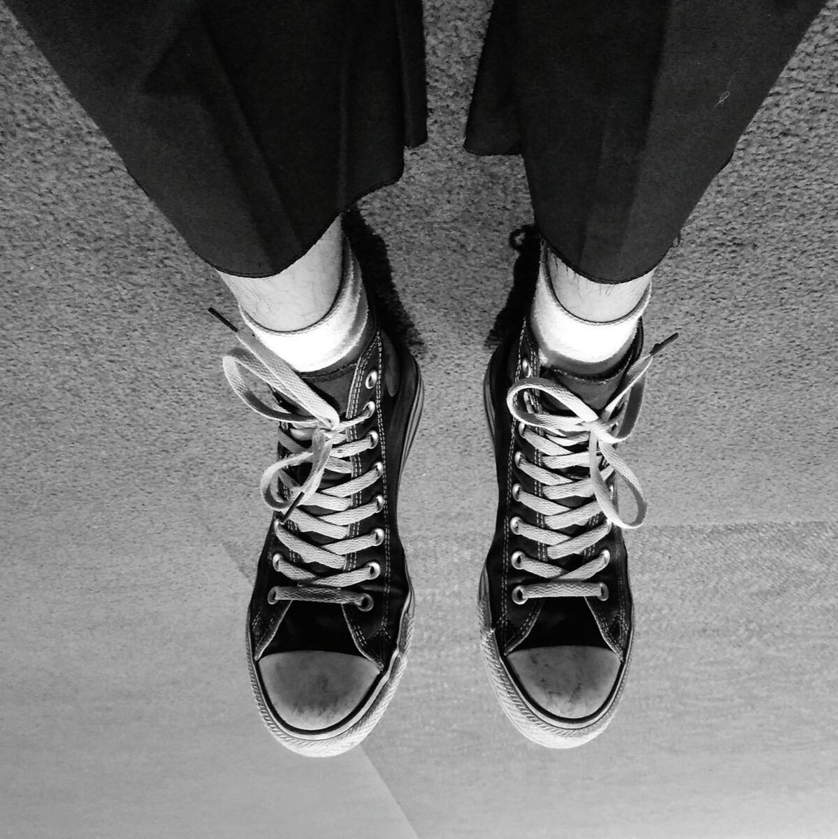 LOW SECTION OF WOMAN STANDING ON TILED FLOOR