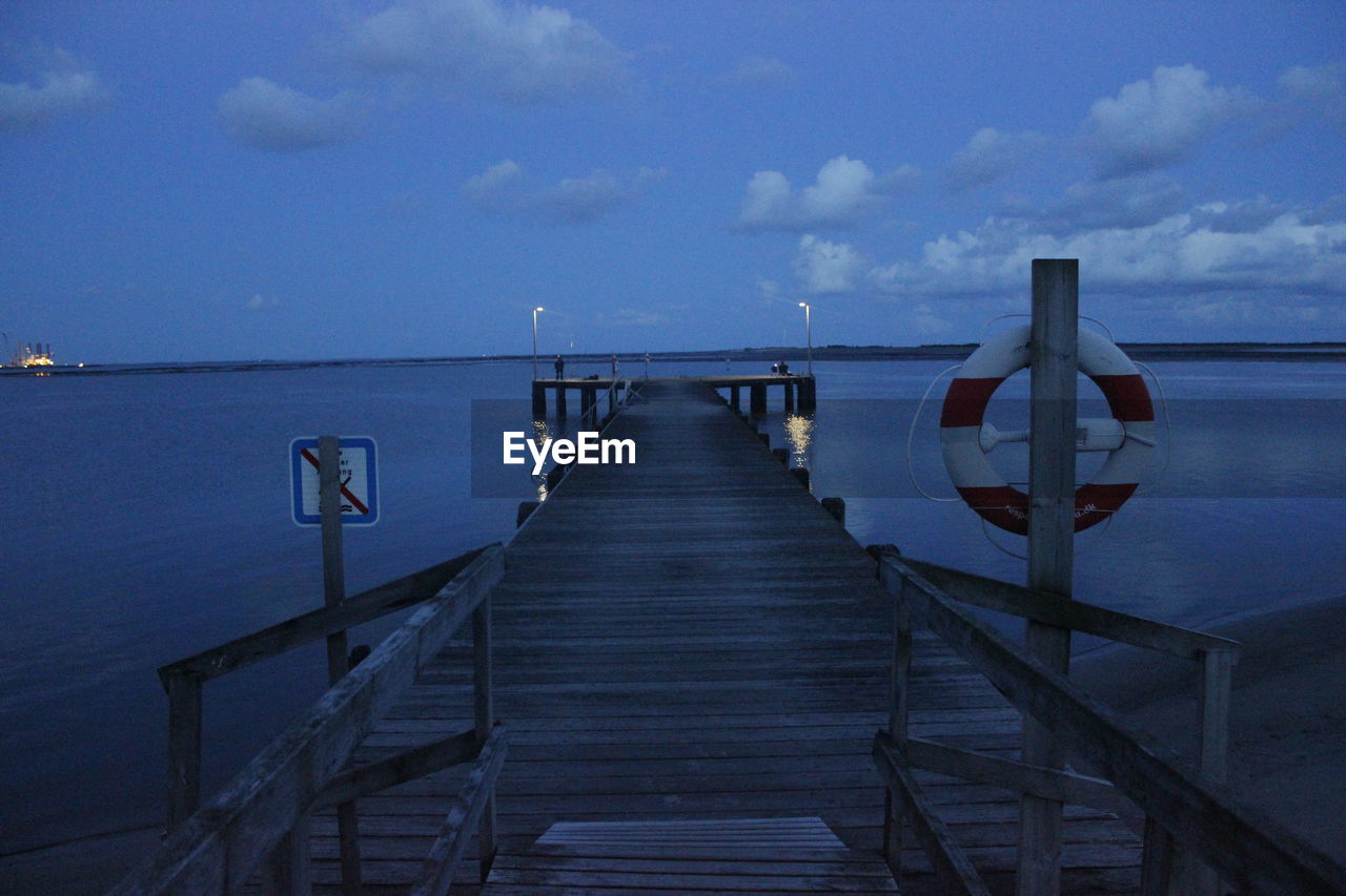 Pier over sea against sky