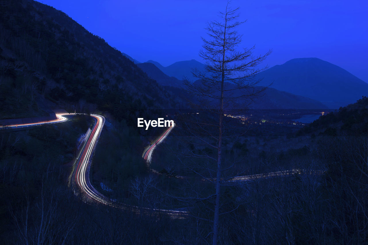 Aerial view of illuminated mountains against sky at night