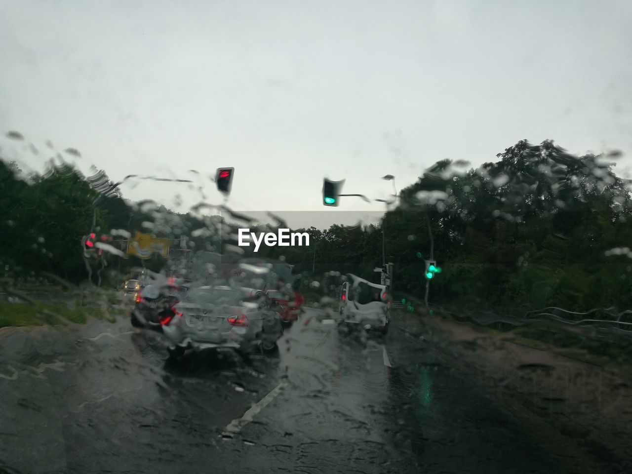 Cars on road seen through wet window