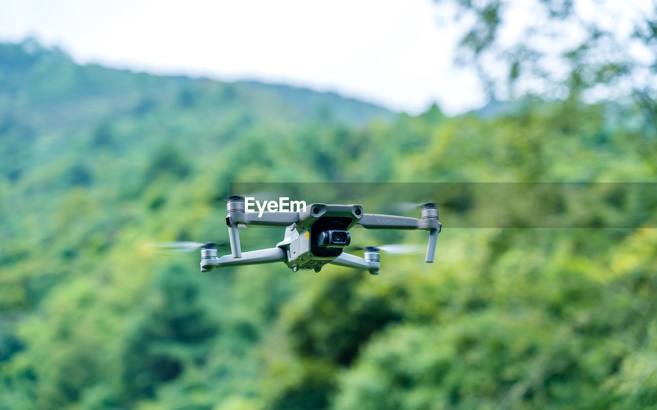 drone, surveillance, air vehicle, flying, technology, mid-air, transportation, no people, aircraft, nature, camera, aviation, vehicle, mode of transportation, motion, focus on foreground, day, airplane, security, outdoors, plant, travel, tree, aerospace industry, sky, media equipment