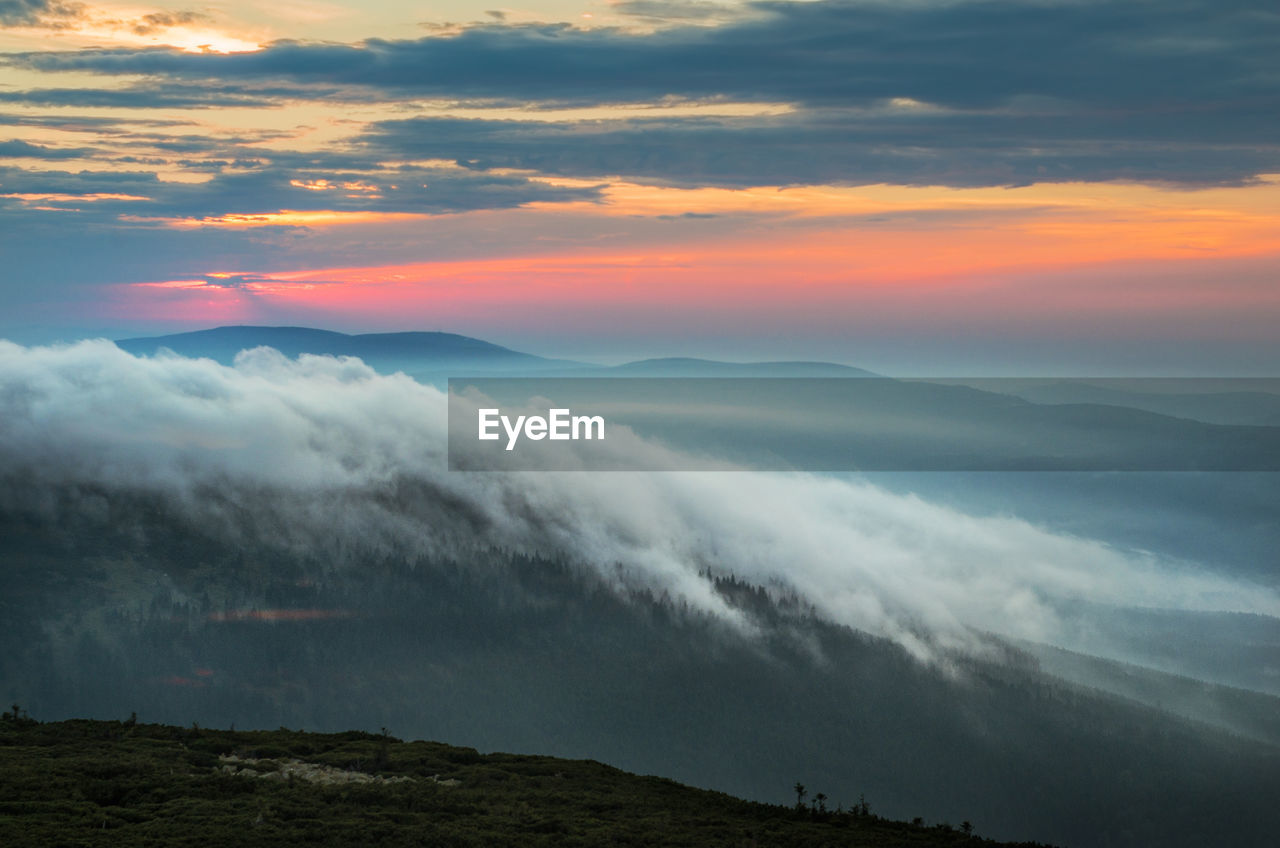 Scenic view of mountains against sky during sunset