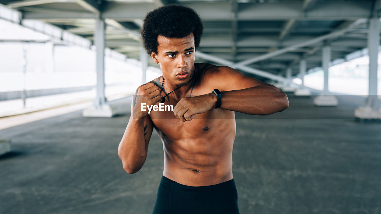 Young man looking away while exercising