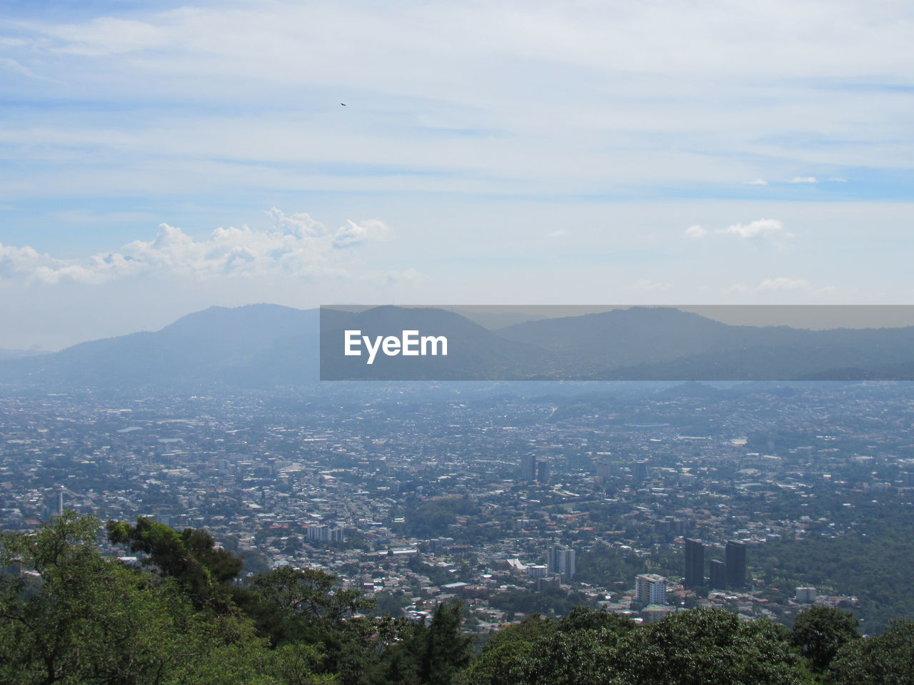 Scenic view of city and buildings against sky