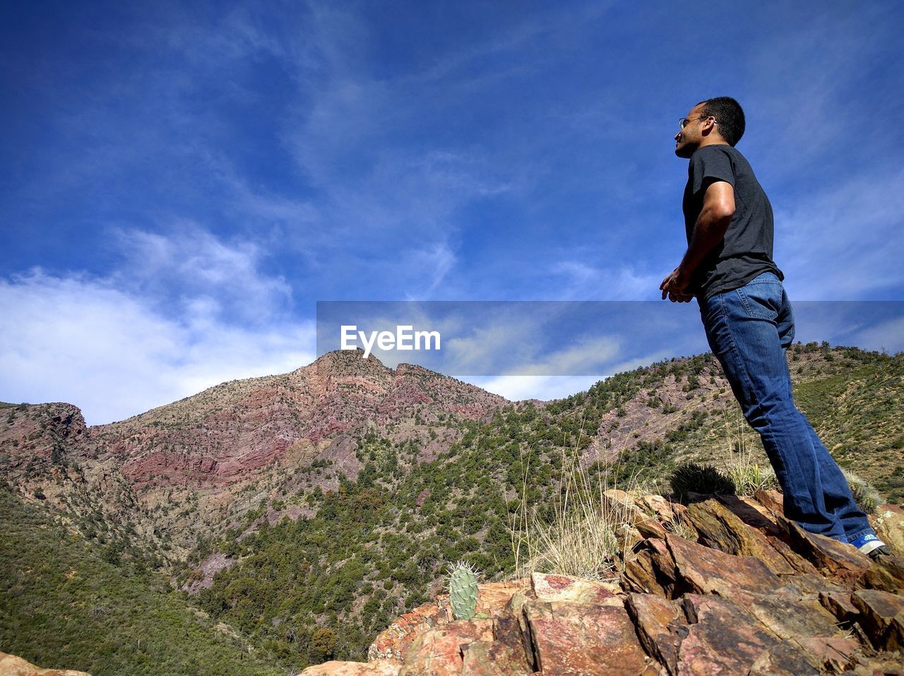 Low angle view of man standing on mountain