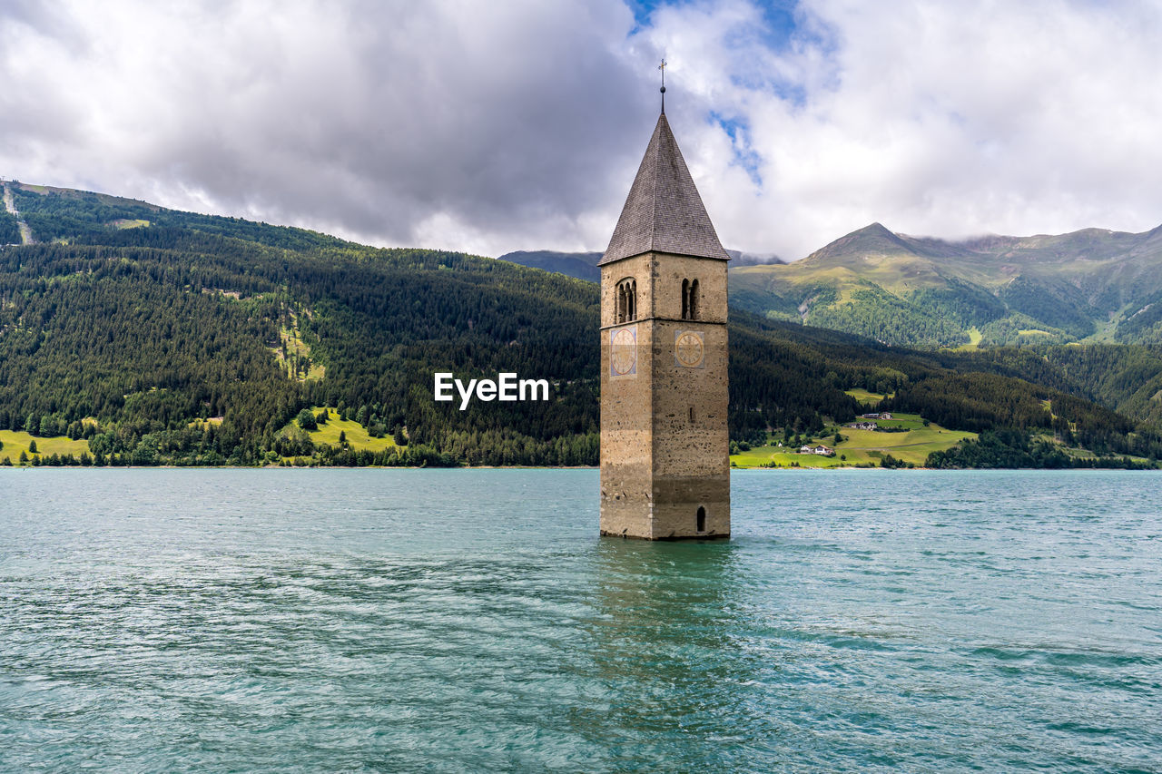 SCENIC VIEW OF LAKE BY BUILDING AGAINST SKY