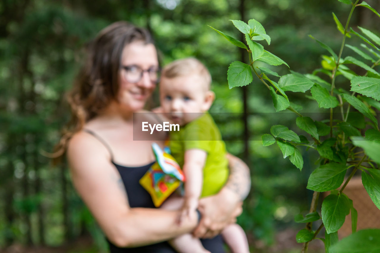 Rear view of mother and son on plant