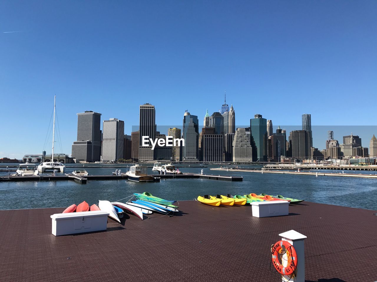 Boats in river with city in background