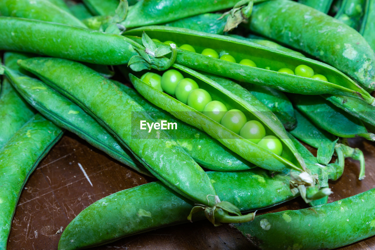 FULL FRAME SHOT OF GREEN CHILI PEPPERS AT MARKET STALL