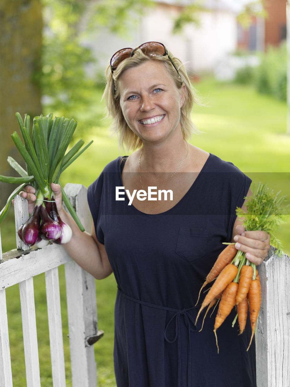 Woman with bunches of vegetables