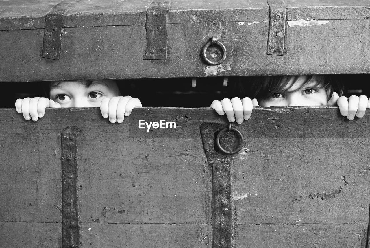 Close-up of children hiding in trunk