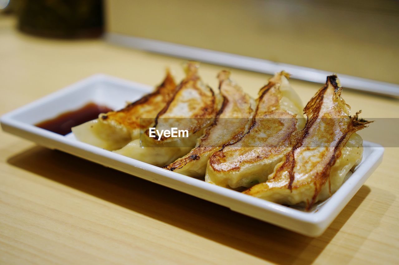 Close-up of food in plate on wooden table