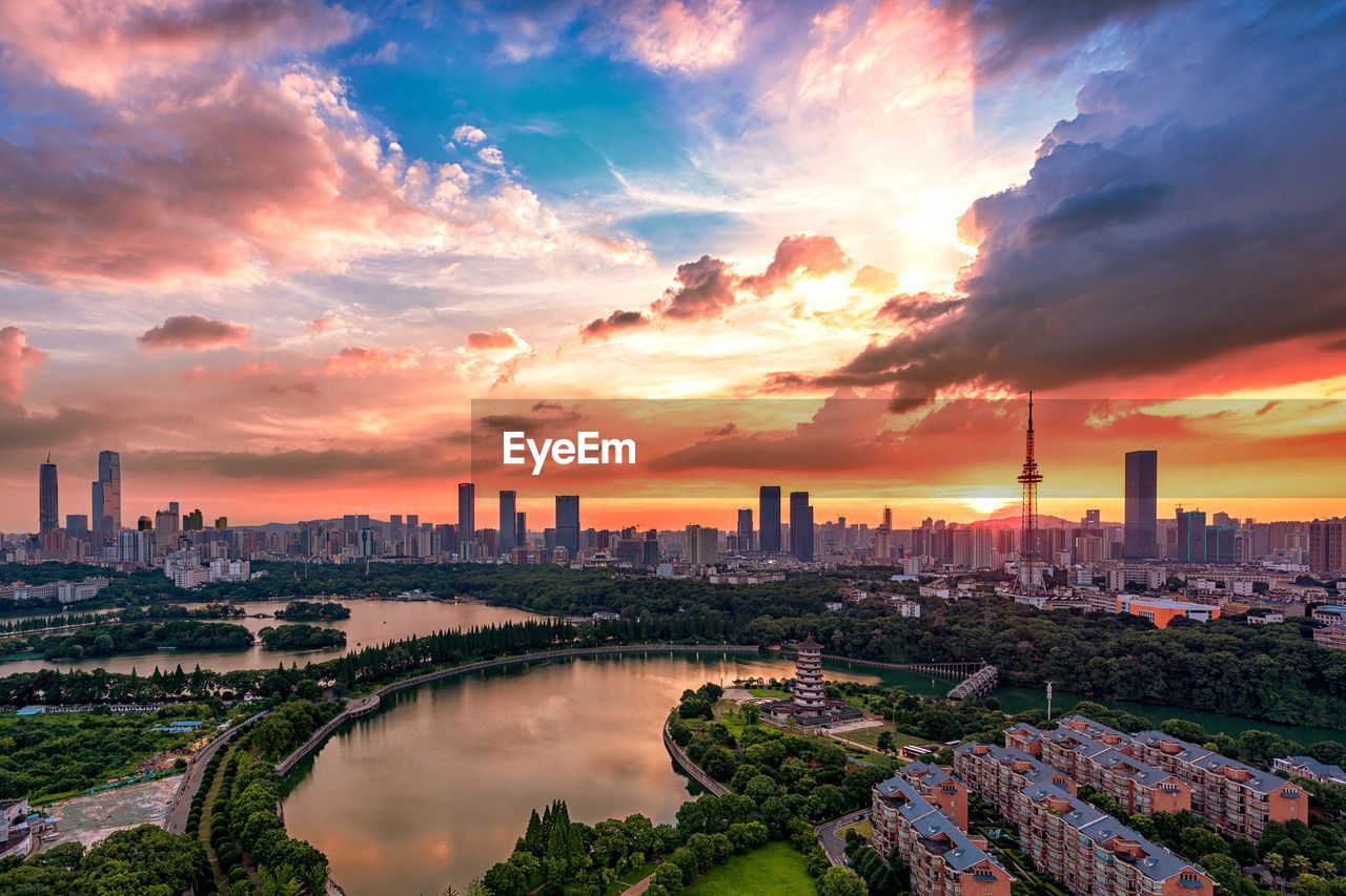 Panoramic view of buildings against cloudy sky during sunset