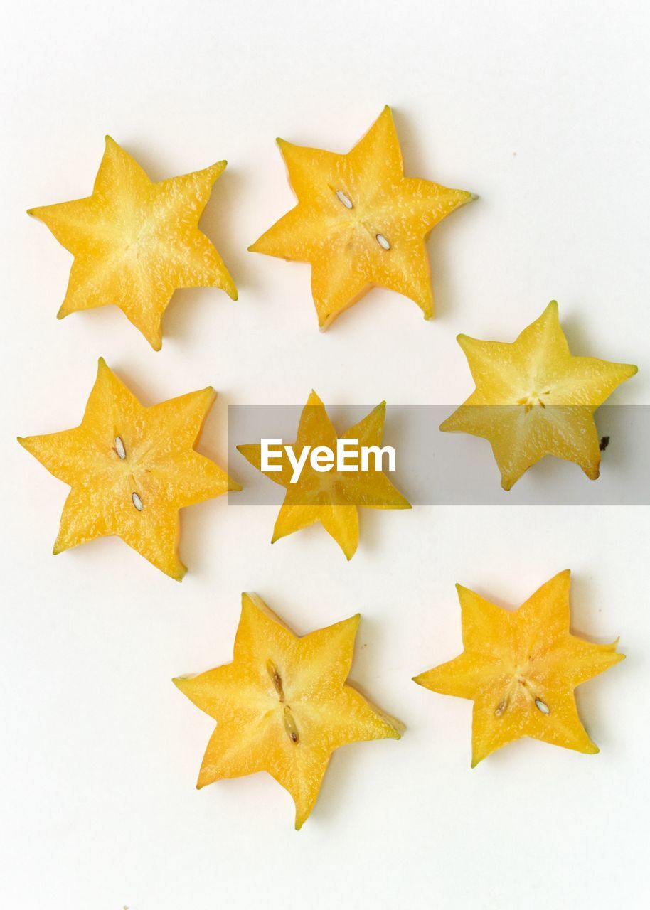 Close-up of star fruit slices against white background