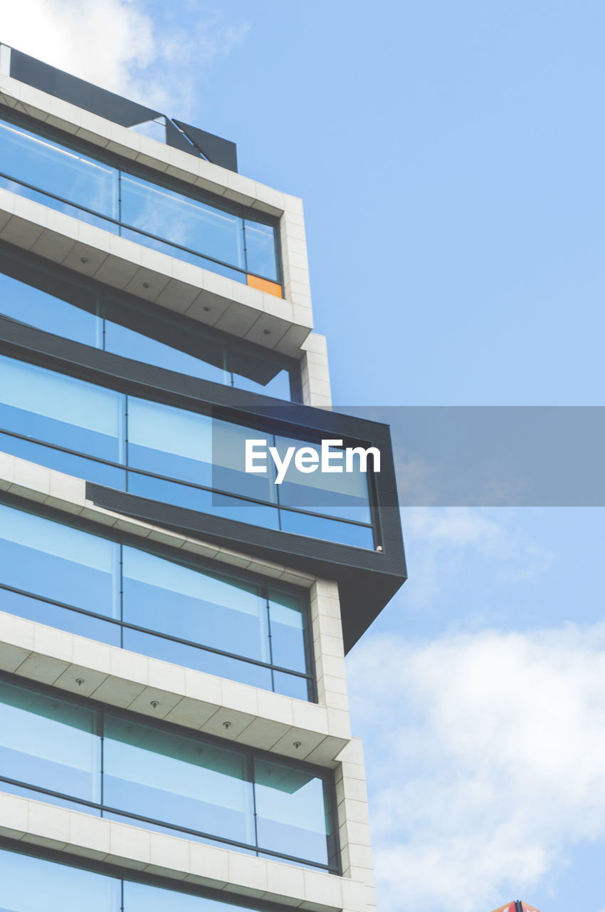 LOW ANGLE VIEW OF BUILDING AGAINST BLUE SKY