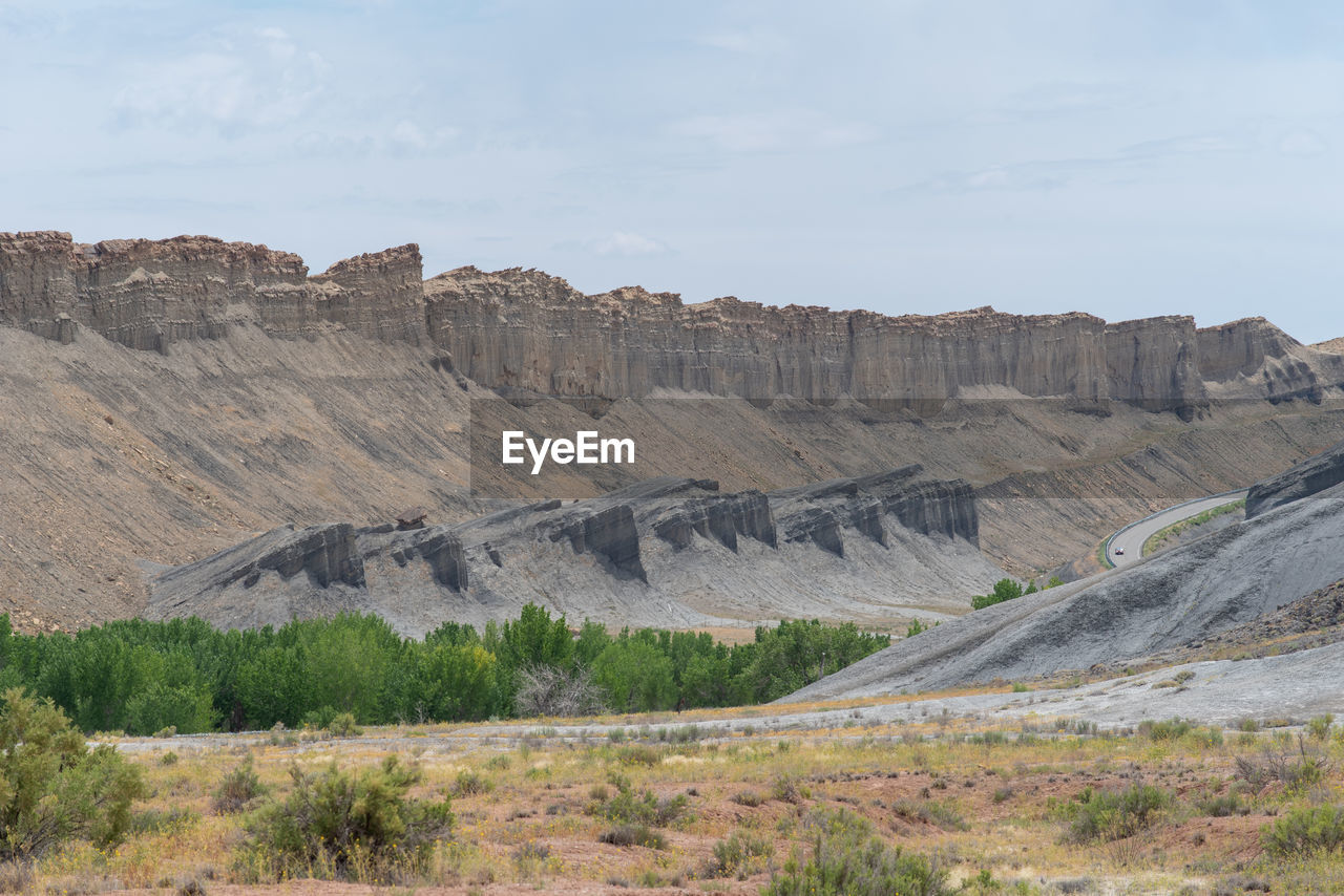 Landscape of barren grey and yellow stone formations near hanksville, utah