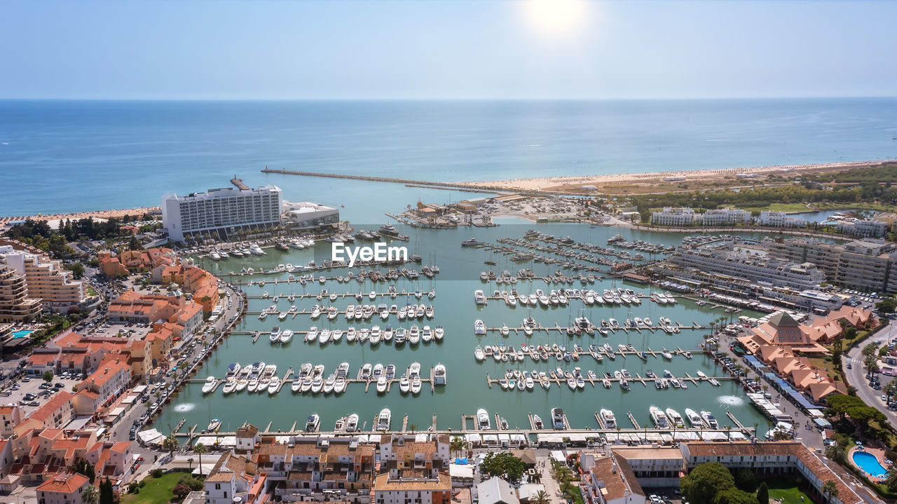 HIGH ANGLE VIEW OF BUILDINGS BY SEA