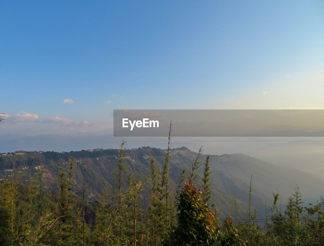 Scenic view of mountains against sky at sunset