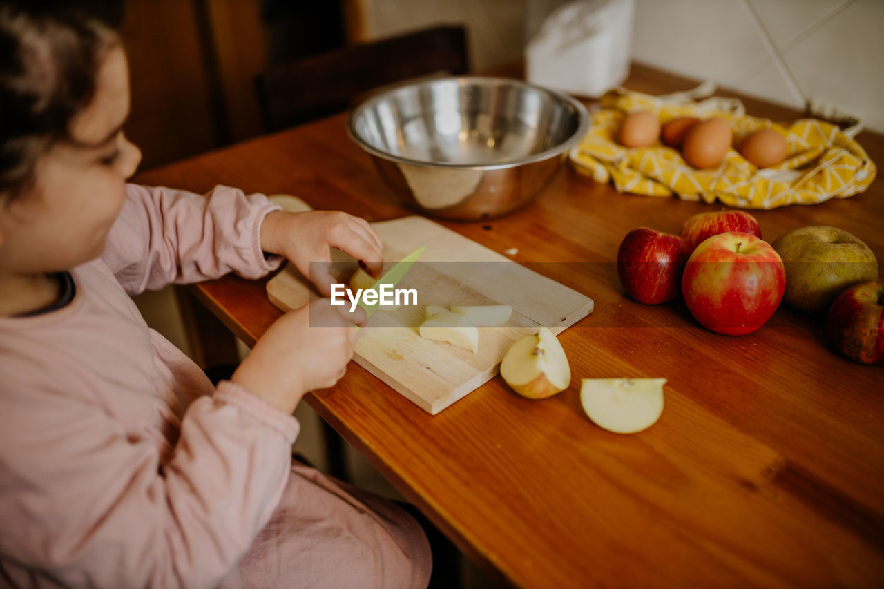 high angle view of boy preparing food at table