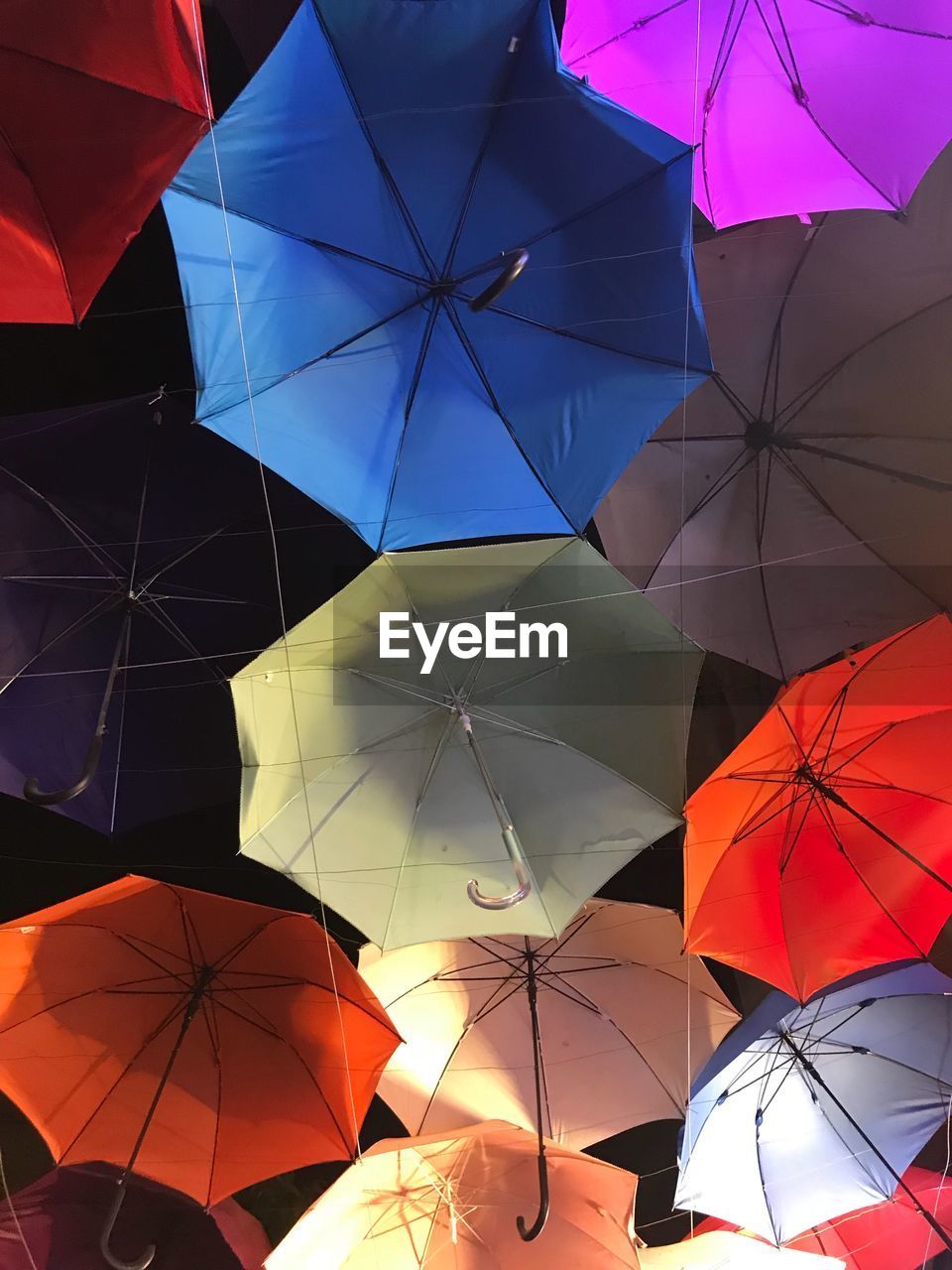 CLOSE-UP OF MULTI COLORED UMBRELLAS