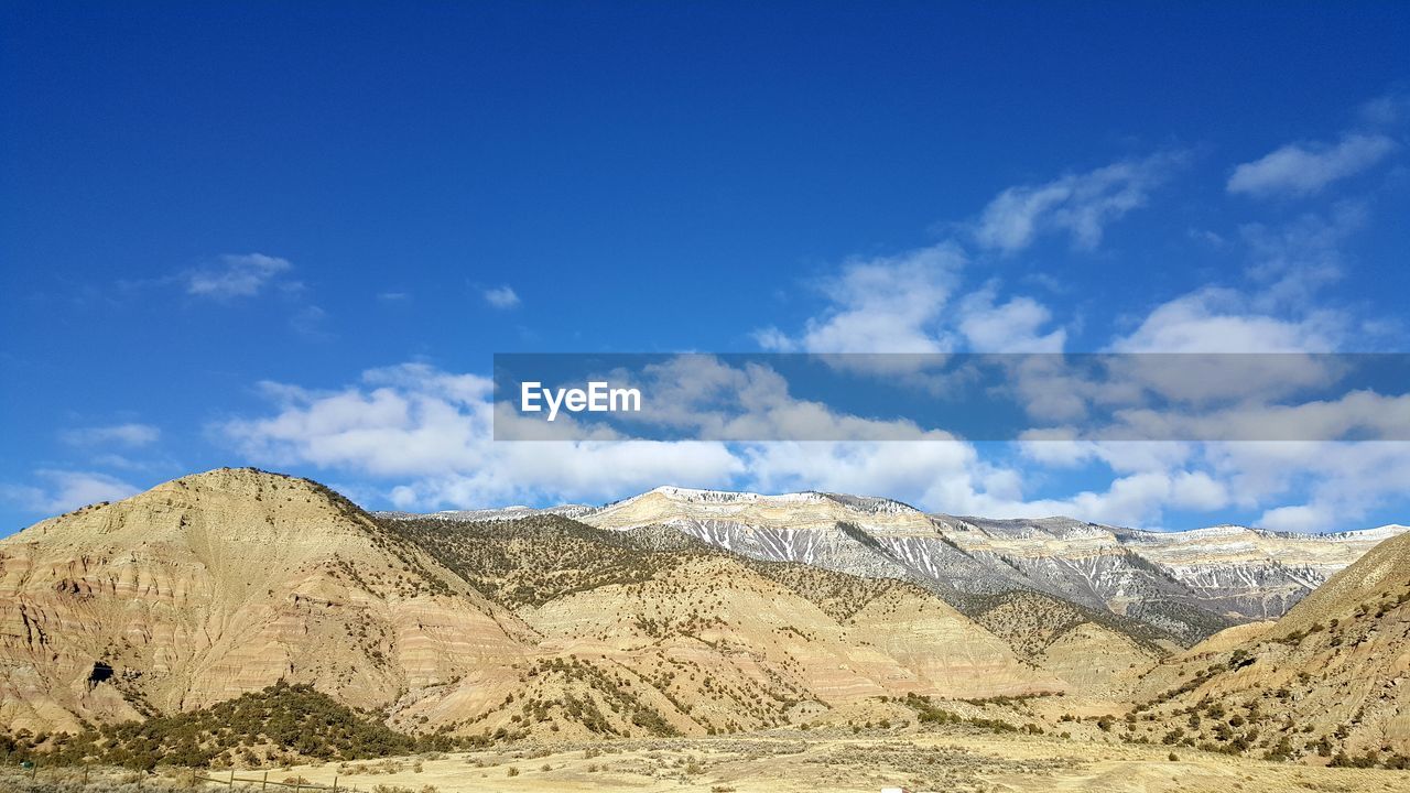 Panoramic view of landscape against blue sky