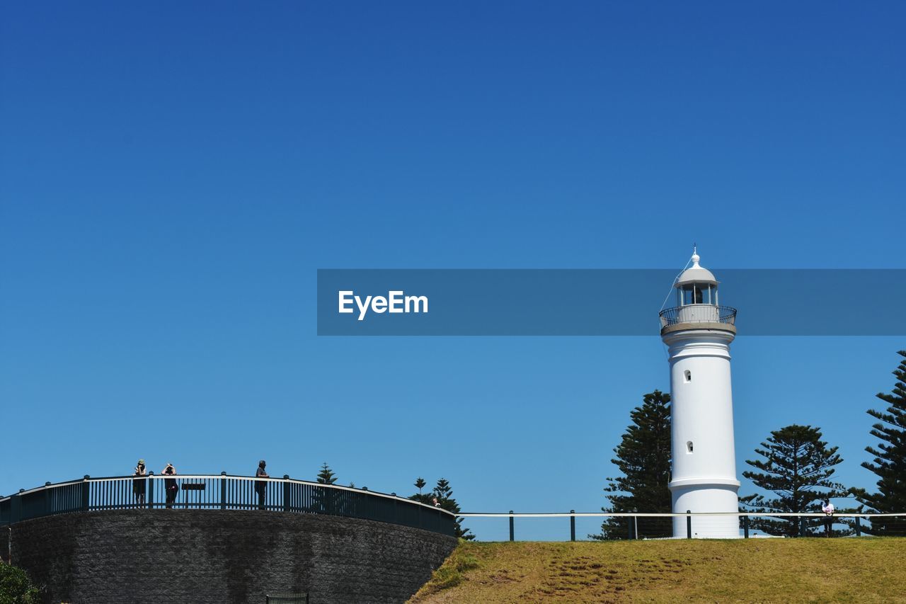 LIGHTHOUSE AGAINST CLEAR BLUE SKY