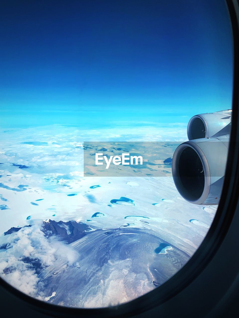 Sky seen through airplane window against blue sky