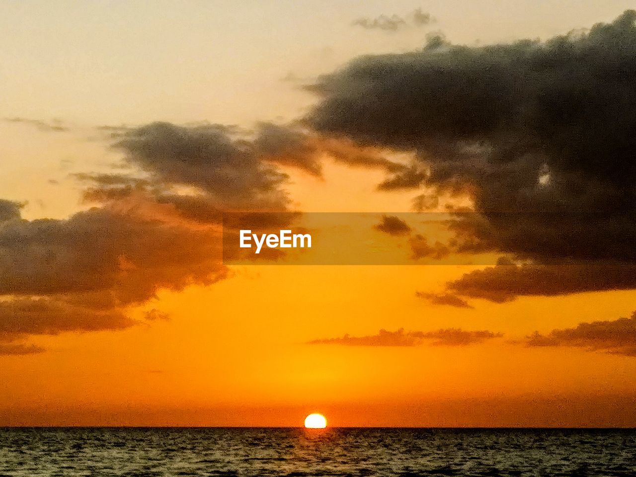 SCENIC VIEW OF SEA AGAINST ORANGE SKY DURING SUNSET