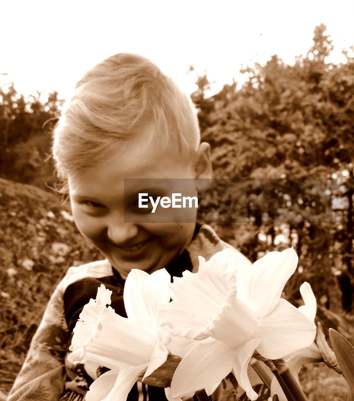 Portrait of smiling boy by flowering plants