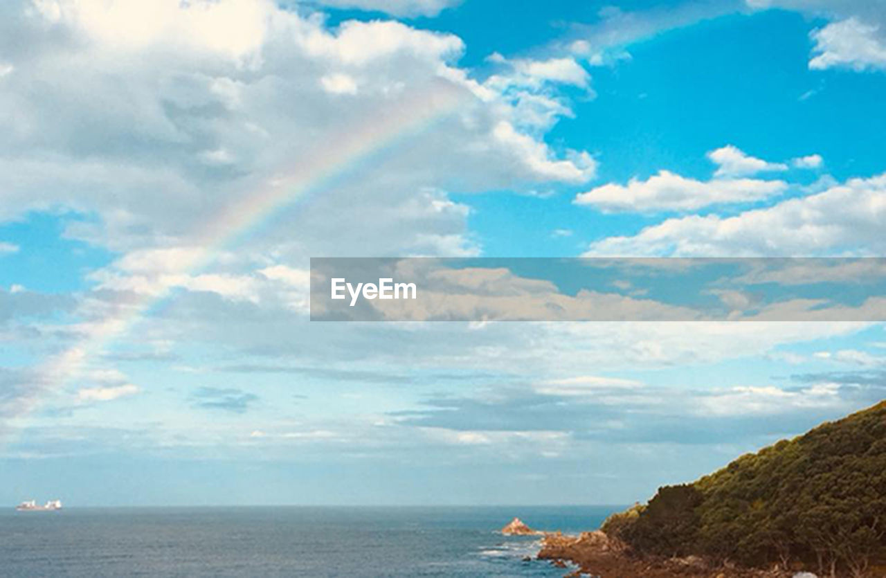 SCENIC VIEW OF SEA AGAINST RAINBOW