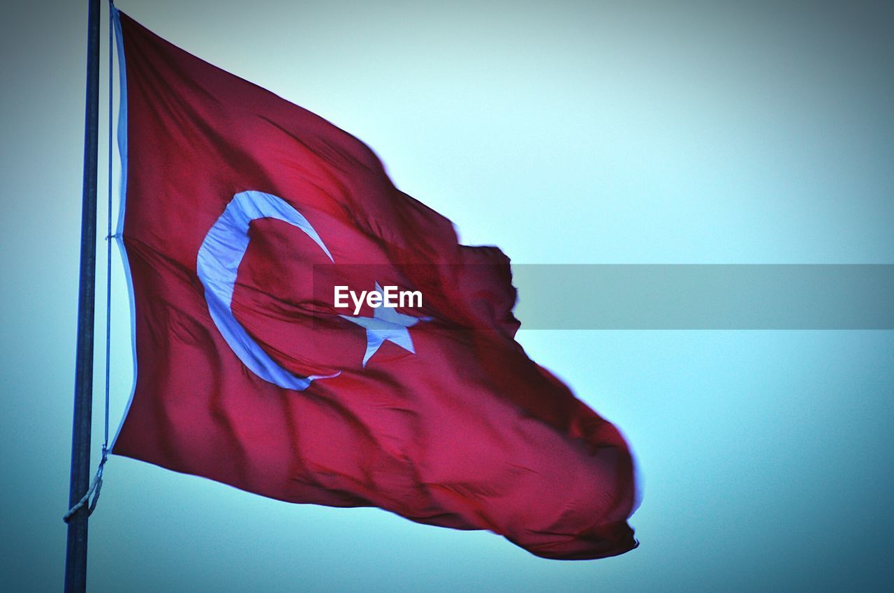 Low angle view of turkish flag against sky