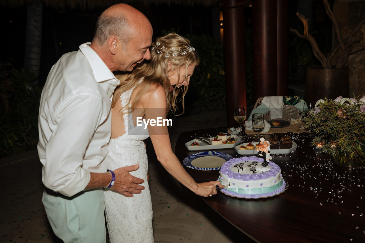 Bride and groom cutting the cake 