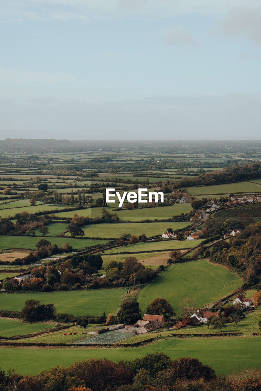 Scenic view of fields and farms from mendip hills, uk, on a sunny autumn day.