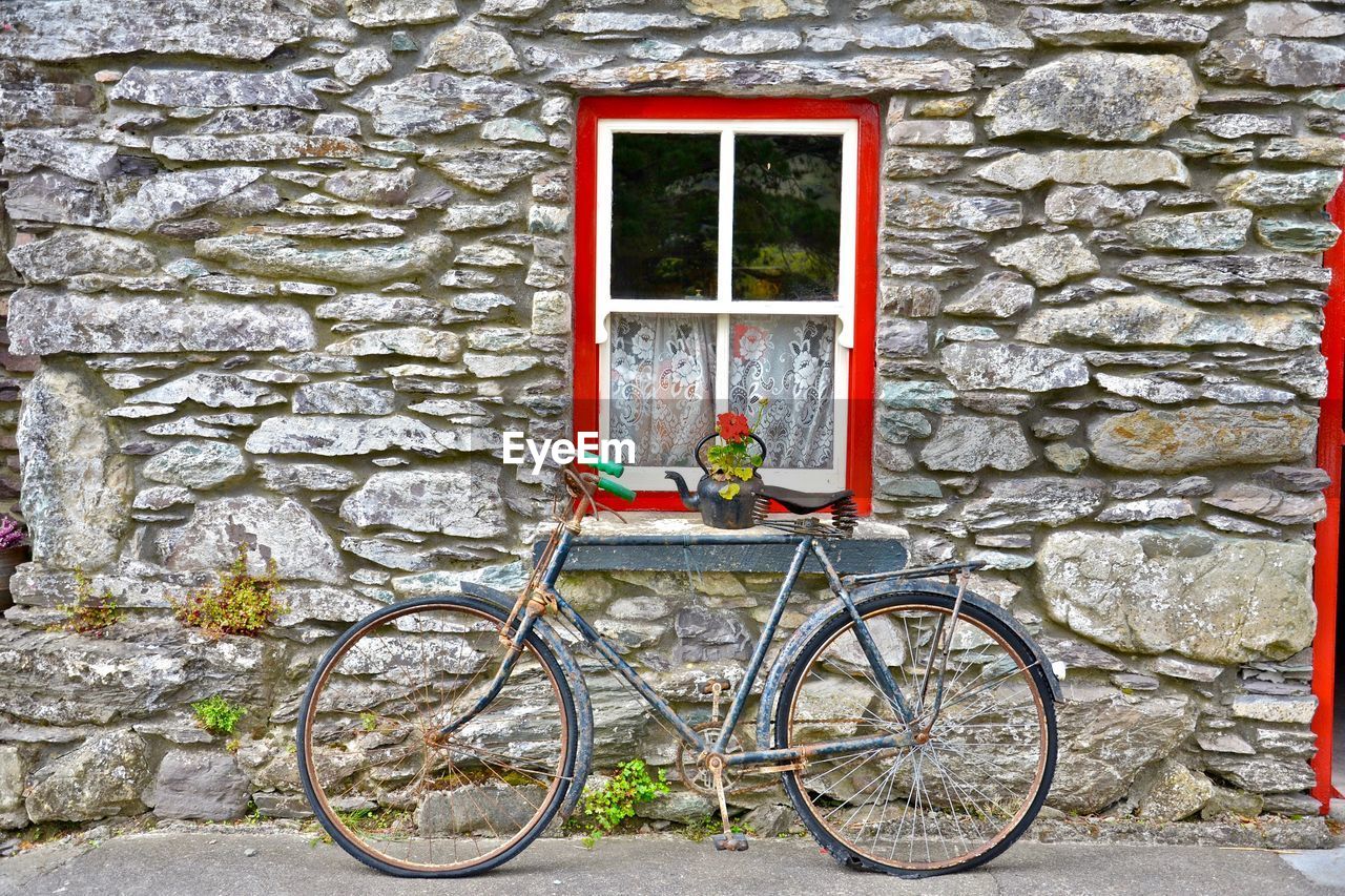 BICYCLE AGAINST BUILDING