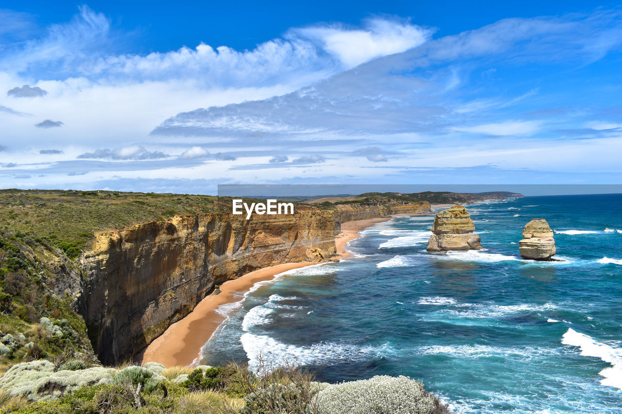 Scenic view of rocky coastline and sea against sky in australia