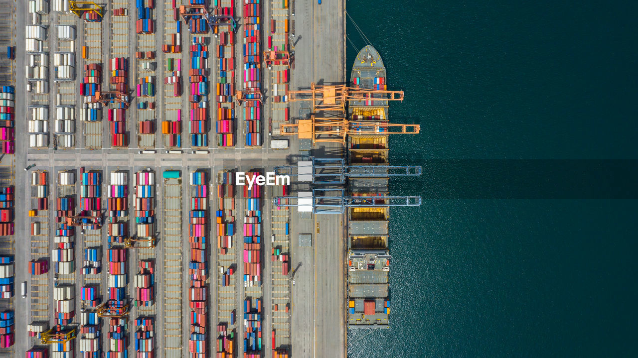 Aerial view of multi colored cargo container by lake