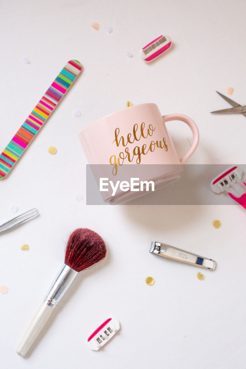 Directly above shot of mug amidst various objects on table