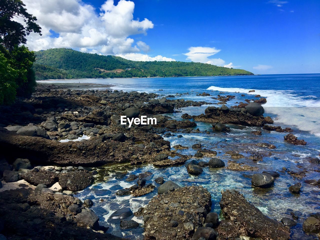 Rocks on beach against sky