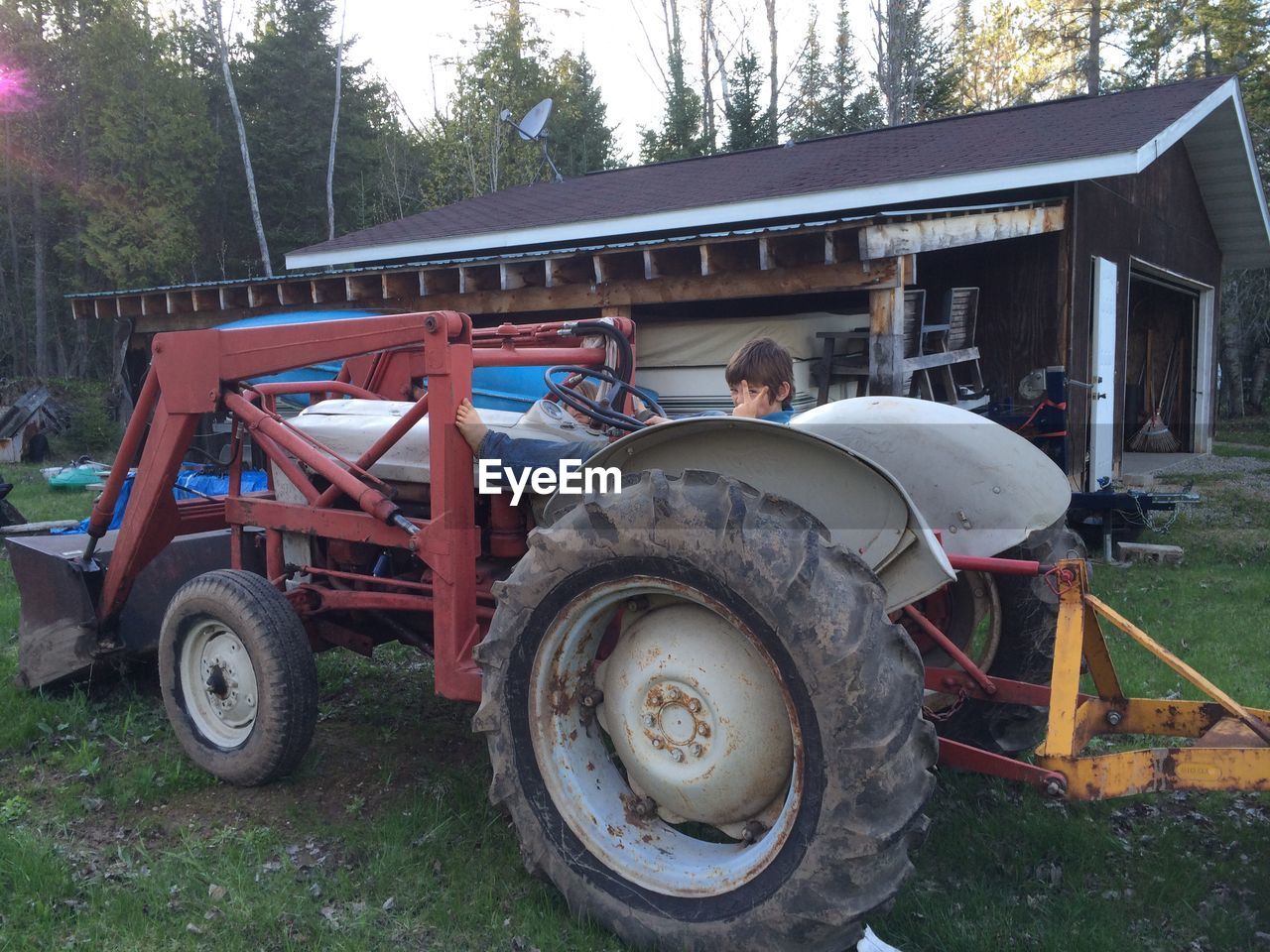 CLOSE-UP OF TRACTOR ON TREE