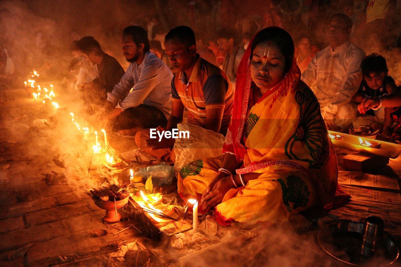 Doing prayer at barodi lokhnath brahmachari ashram infront of burning candle and diya- oil lamp