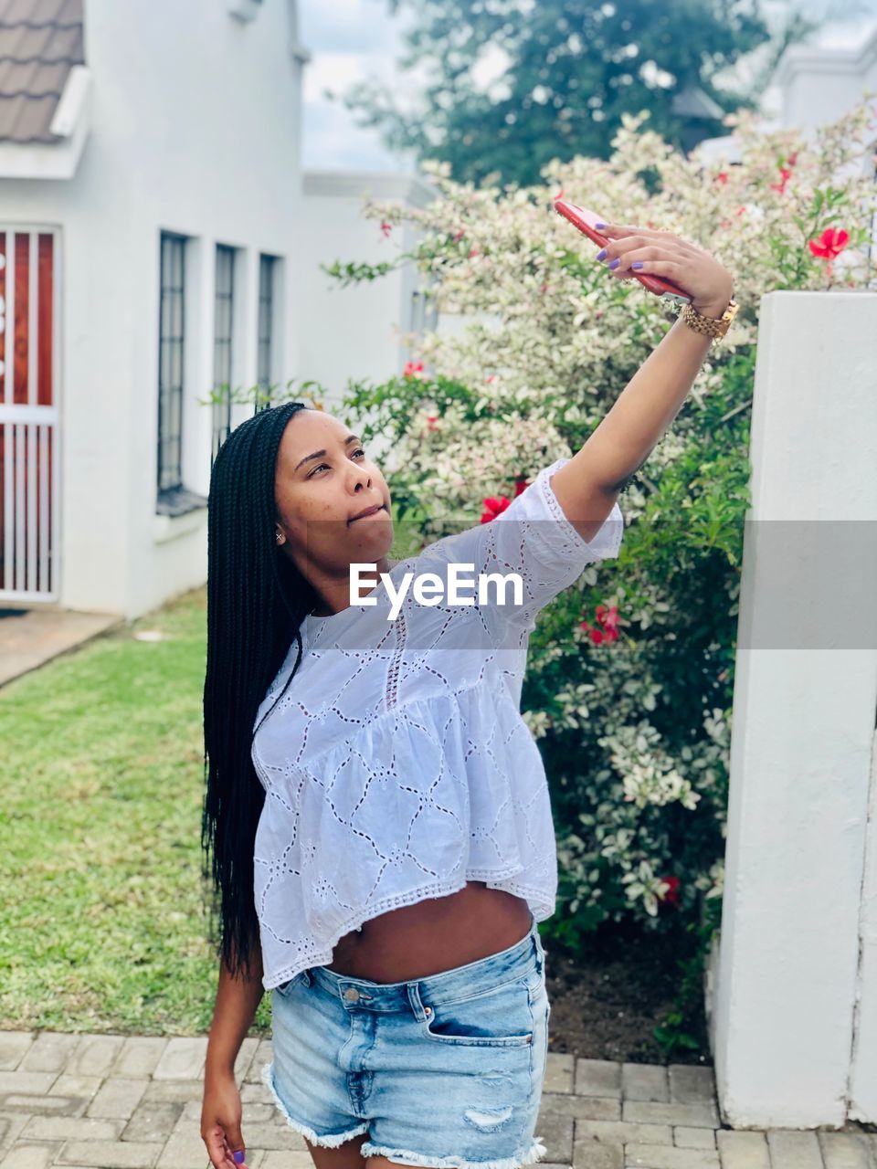 Woman taking selfie while standing in yard