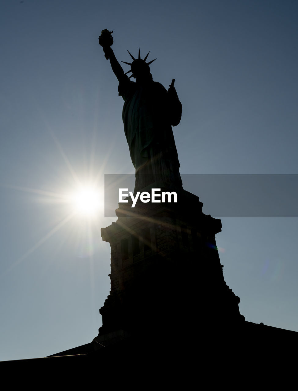 LOW ANGLE VIEW OF STATUE AGAINST SKY AT SUNSET