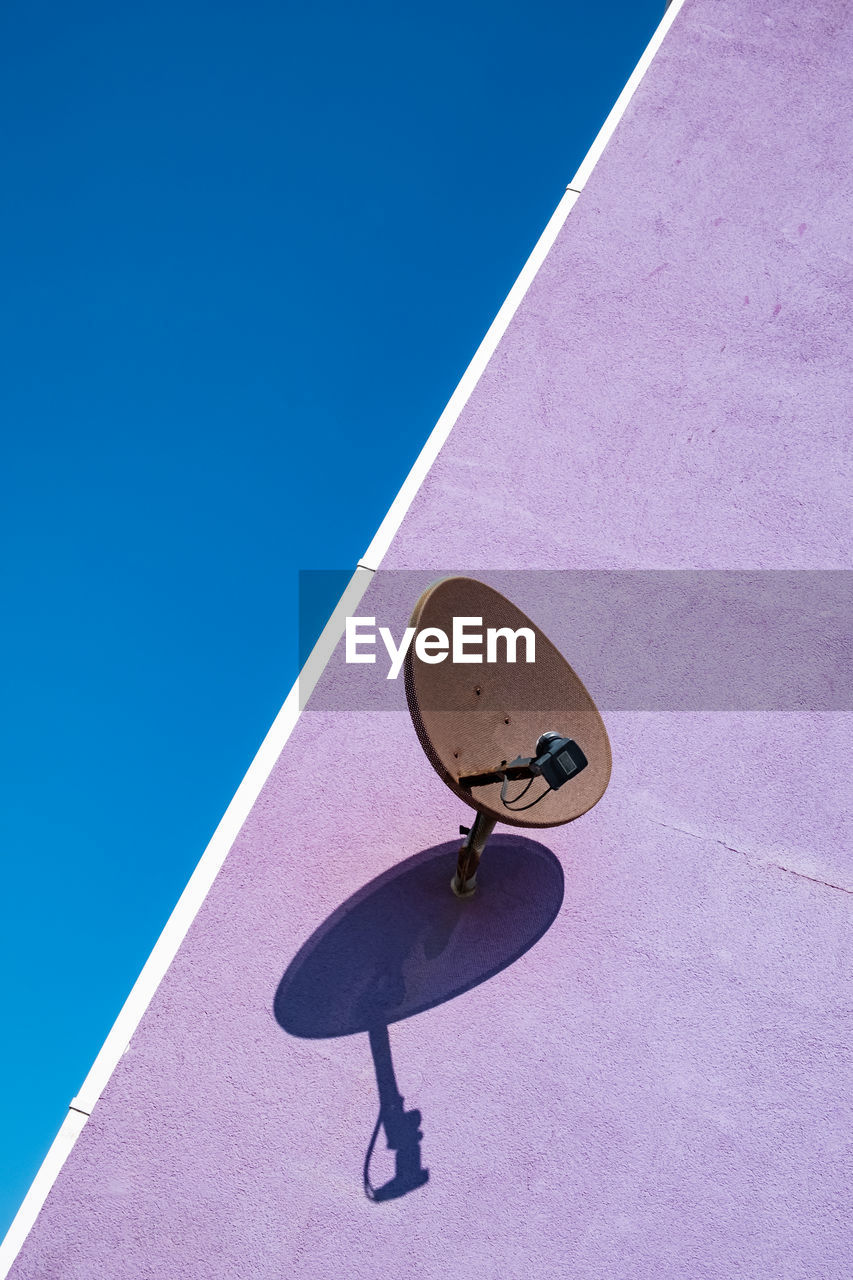 Low angle view of satellite dish against blue sky