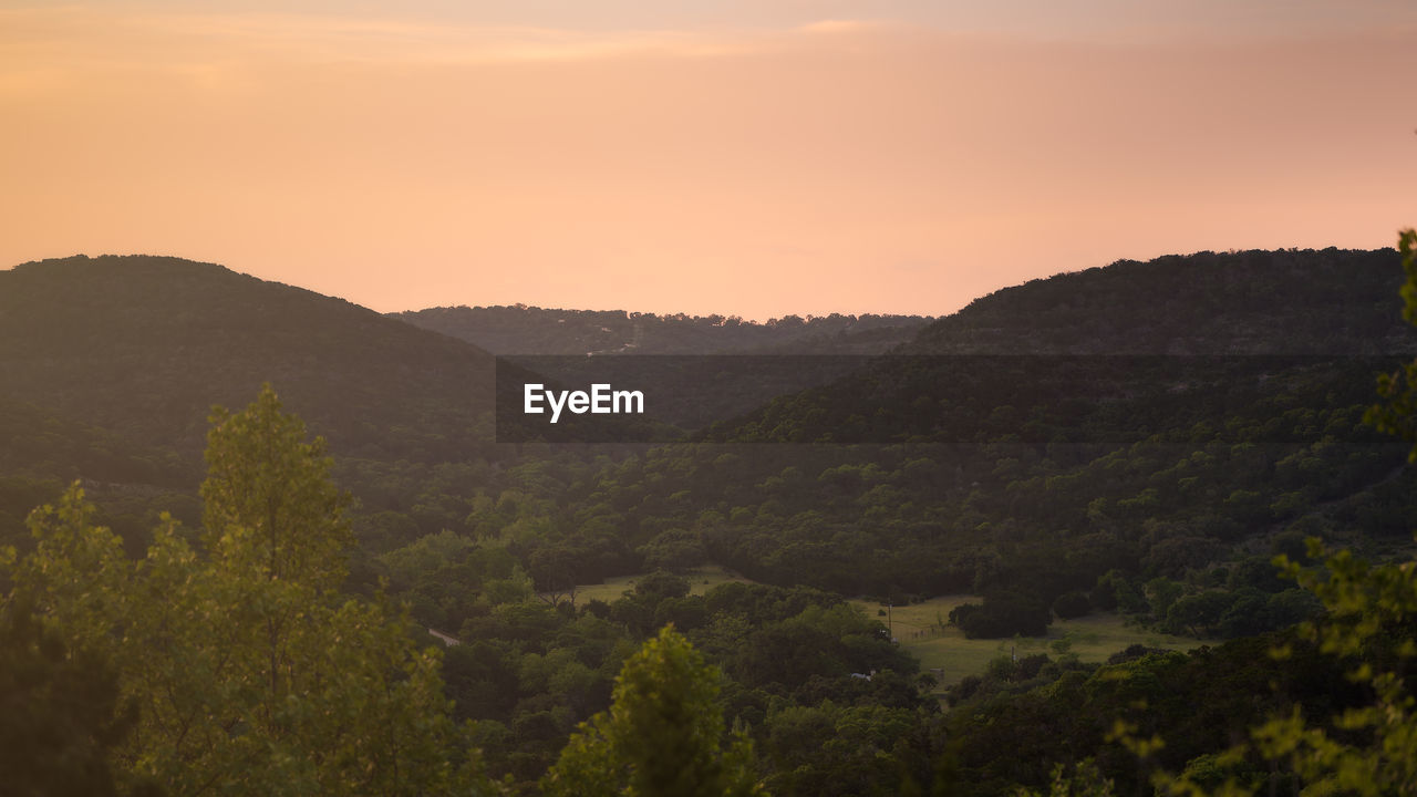 SCENIC VIEW OF MOUNTAINS DURING SUNSET