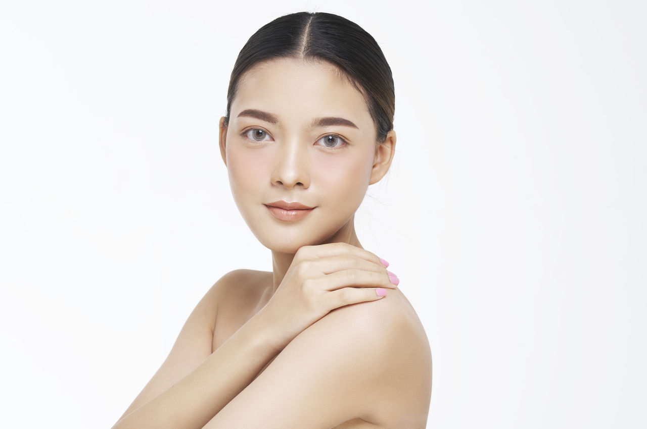 Portrait of beautiful young woman over white background