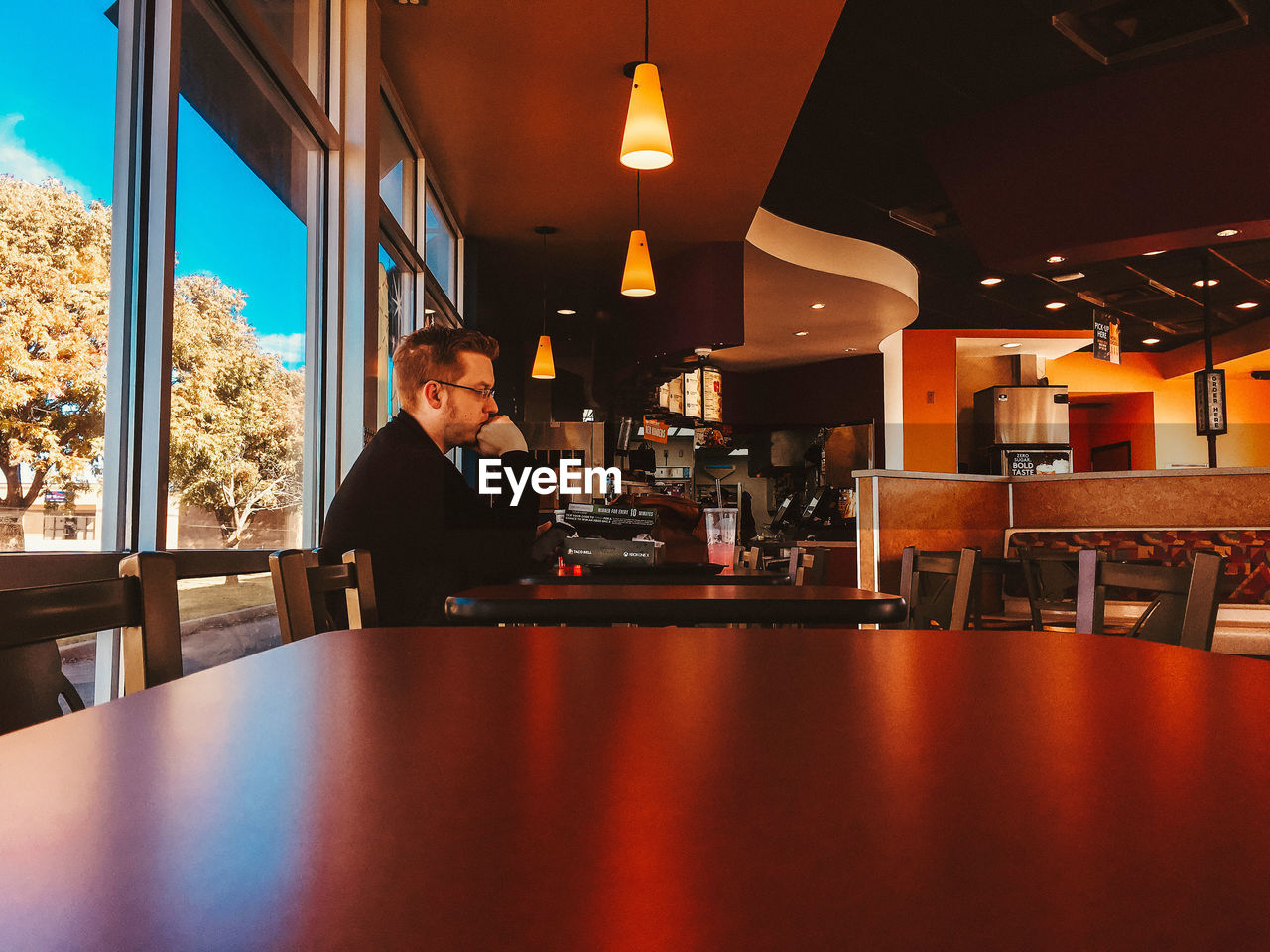 Side view of man sitting in restaurant