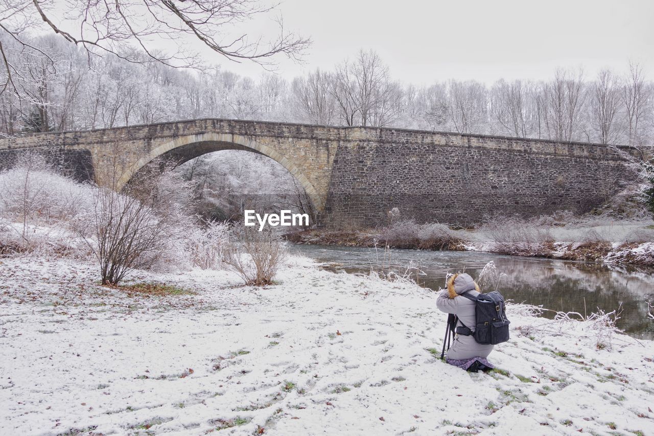 Rear view of person on snow covered land