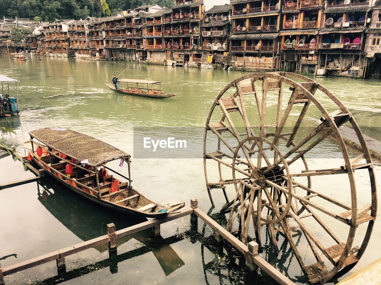 HIGH ANGLE VIEW OF BOATS MOORED AT RIVERBANK